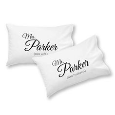 two white pillows with black lettering on them