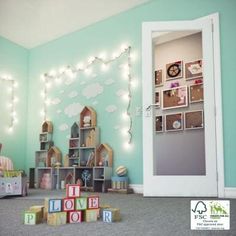 a child's room with toys and lights on the wall