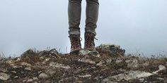 a person standing on top of a rocky hill