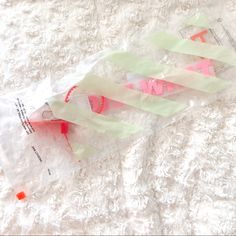 a plastic bag filled with candy on top of a white blanket