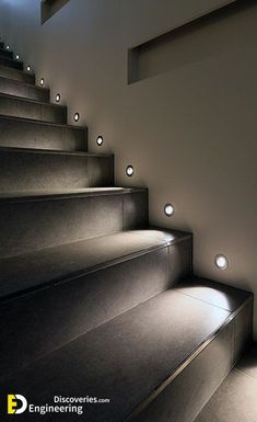 an illuminated staircase leading up to the top floor