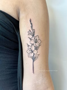 a black and white flower tattoo on the arm