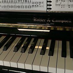 an upright piano with sheet music on it