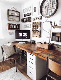 a desk with a computer on top of it in front of a wall full of pictures