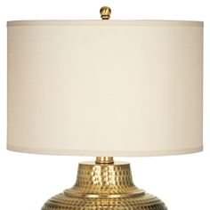 a gold table lamp with a white shade