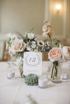 a table with flowers and candles on it