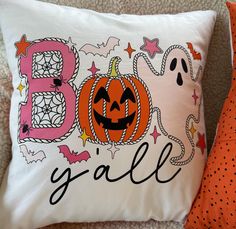 a halloween pillow that says boo y'all with a jack o lantern on it