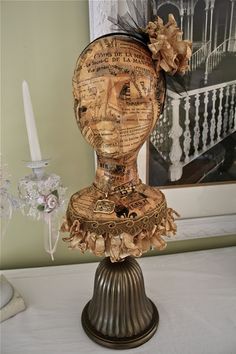 a wooden head on top of a metal stand