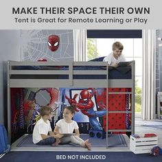 two boys sitting on the bottom bunk of a bed with spiderman wall decals