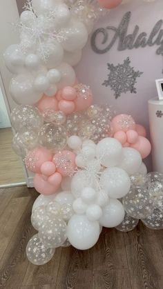 balloon arch with snowflakes, stars and sparkles on the top for a winter themed baby shower