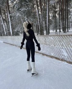 a woman riding skis down a snow covered slope