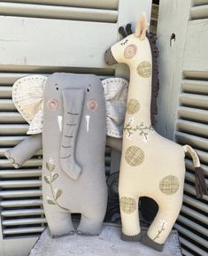 two stuffed giraffes sitting next to each other