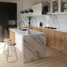 a modern kitchen with marble counter tops and wooden stools next to the bar area