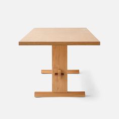 a square wooden table with two legs on each side and one end at the top