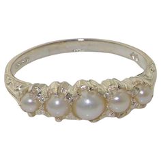 This stunning ring is made from 10K White Gold fitted with Cultured Freshwater Pearls. Beautifully Handcrafted from Solid English 10K White Gold and Tested and Hallmarked by the London Assay Office. The Hallmark includes the 417 marking plus the Leopard's Head and the Royal Crown. The Pearls are Freshwater Cultured Pearls that are hand selected and hand set. The pearls measure 4 mm, 3 mm & 2.75 mm (0.16",0.12" & 0.11" inches) If you know your US, UK, Australian or European Finger Size then please include this as a note attached to your order otherwise we will work to the size you have selected. CUSTOMIZE THIS RING This ring can be customized to your requirements - 9K, 10K, 14K, or 18K in Yellow, Rose or White Gold or Platinum and whatever stone combination you would like. If I don't have t Vintage White Gold Ring, Pearl Wedding Ring Vintage, Pearl Wedding Bands, Regency Wedding, Pearl Rings Vintage, Flower Rings, Pearl Vintage, Half Eternity Band, Crown Ring