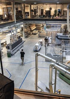 the inside of a factory with workers working on machines and equipment in it's center