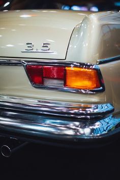 the rear end of an old white car