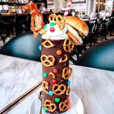 a tall chocolate milkshake with pretzels and candy