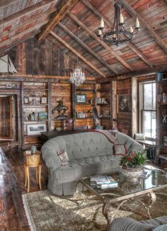 a living room filled with furniture and a chandelier