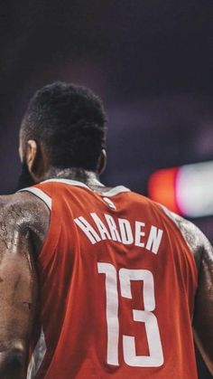 the back of a basketball player wearing an orange jersey