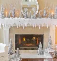 a living room decorated for christmas with silver trees and snowflakes on the mantle