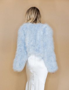 Once in a while, right in the middle of an ordinary life, loves gives you a fairytale. Whether your a lady that embraces elegance, grace and finesse with polished style or a gorgeous winter bride, be sure to find your special piece to compliment your style. Hand Dyed Luxurious Marabou Feather Jacket Hook/eye front closure Cropped style design with rounded front and 3/4 length sleeves Made from Ethically sourced 100% Marabou Feathers Silk Satin Lining Lightweight Made of by-product materials Feather Cape, Mongolian Fur, Feather Jacket, Fur Cape, Winter Bride, Velvet Jacket, Pearl Collection, Cropped Style, Crop Jacket