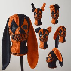 an assortment of knitted animal heads with ears and tails, all in orange and black