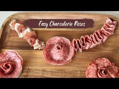 some raw meats on a wooden cutting board