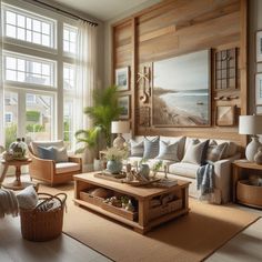 a living room filled with lots of furniture and large windows overlooking the beach in front of it