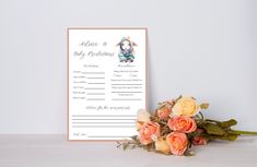 a bouquet of flowers sitting on top of a table next to a baby announcement card