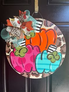 a door hanger decorated with colorful fall decorations