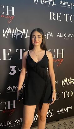 a woman standing on top of a red carpet