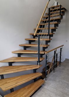 a set of wooden stairs with metal handrails