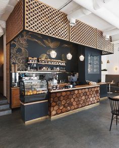 the interior of a coffee shop with wood paneling