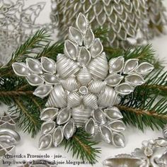 some silver ornaments and pine cones on a table