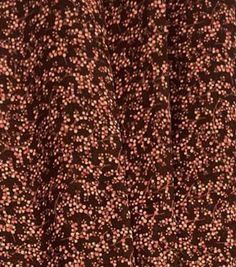 a close up view of the fabric with brown and pink dots on it's surface