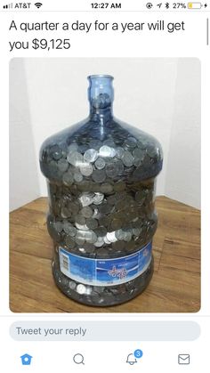 a large jar filled with coins sitting on top of a wooden table