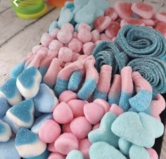 there are many different types of marshmallows on the table, including blue and pink