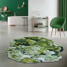 a living room with green walls and rugs on the floor in front of a chair