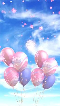 pink and blue balloons floating in the air