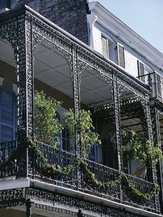 an ornate balcony with wrought iron railing and balconies on the second story of a building