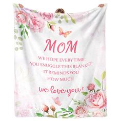 a pink and white wall hanging with roses on it that says, mom we hope every time you snuggle this blanket