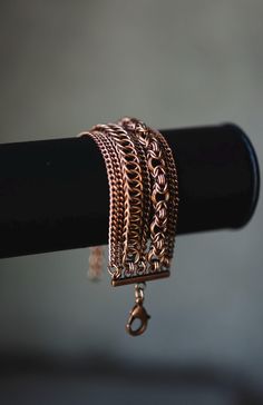 Discover the artisan craftsmanship of this handmade copper-plated cuff bracelet, showcasing two intricate chainmail weaves. Each bracelet is meticulously crafted with attention to detail, offering a blend of rustic charm and modern elegance. The copper plating adds warmth and character to the piece, making it a versatile accessory for any occasion. Choose from a secure lobster clasp closure or custom sizing for a perfect fit. Lightweight and comfortable, this bracelet is ideal for everyday wear Handmade Copper Bracelet, Chainmaille Jewelry Patterns, Etched Jewelry, Chainmail Bracelet, Hardware Jewelry, Wire Wrapped Stone Jewelry, Copper Jewellery, Chainmail Jewelry, Wire Wrap Jewelry Designs