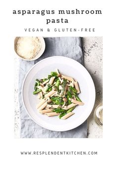 a white plate topped with pasta next to a bowl of spinach and parsley