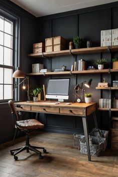 a desk with a computer on top of it in front of a window and bookshelves