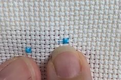 a person's toe with small blue flowers on it, and one nail is missing