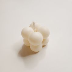 a bunch of grapes sitting on top of a white table