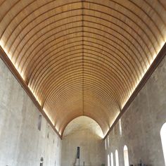 the inside of a large church with pews and stained glass windows on both sides