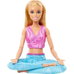 a barbie doll sitting in the middle of a yoga pose