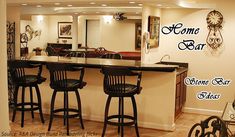 a bar with four stools in front of it and a clock on the wall